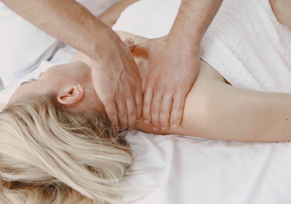 Massage relaxant de la nuque et de l'épaule sur une personne allongée